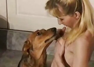 Ponytailed blonde with nice trimmed bush fucks brown dog on the floor