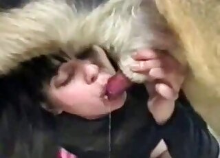 Hot brunette dressed in black sucking on a dog's dick and fucking