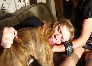 Blond-haired lady puts a dog's cock in her mouth and cums as well